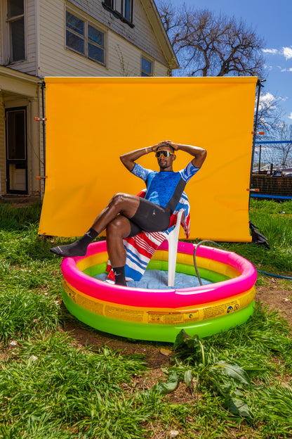 Lifestyle photo of Ardei men's cycling bib shorts in backyard kiddie pool
