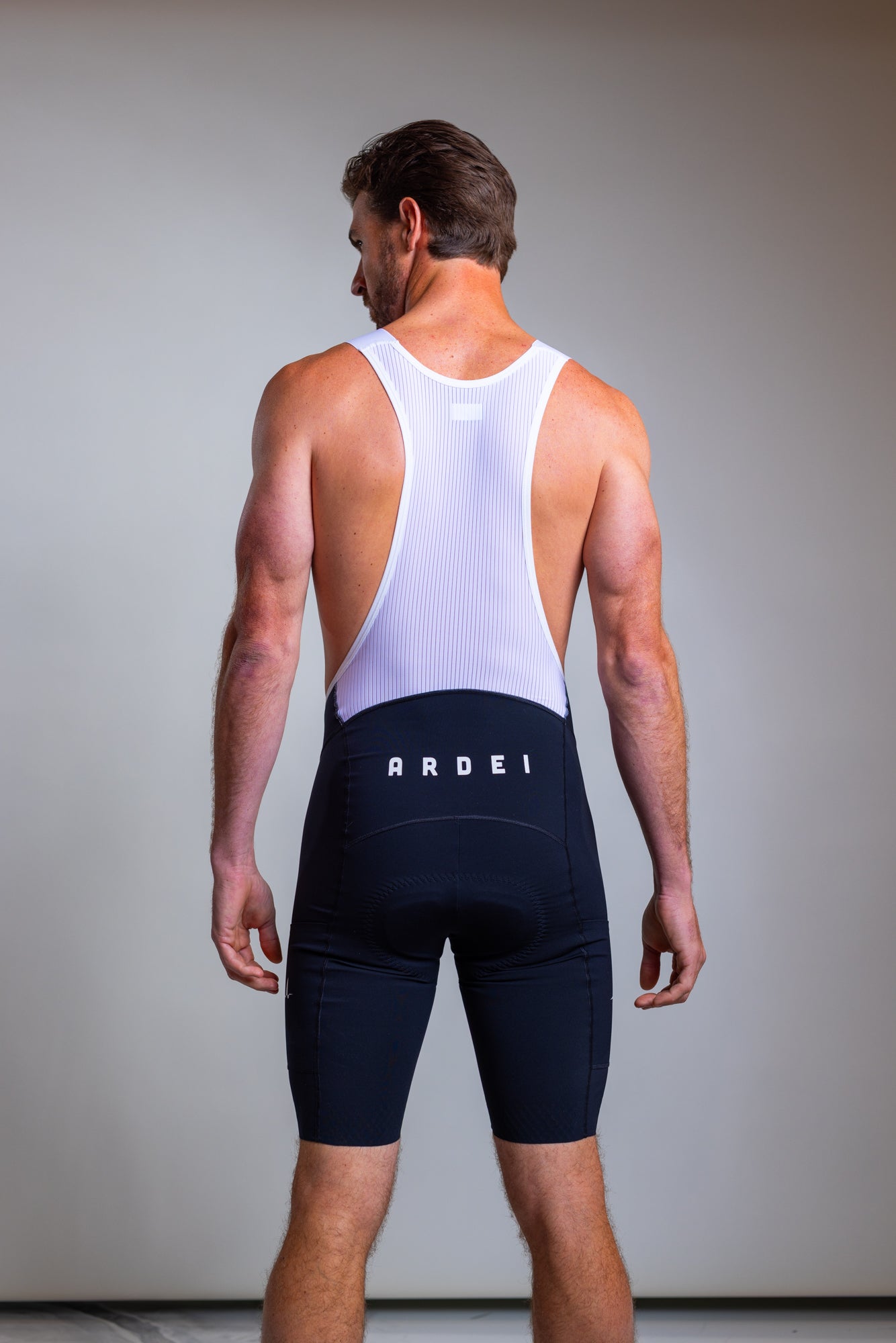 Rear full-body view of Ardei men's cycling bib shorts