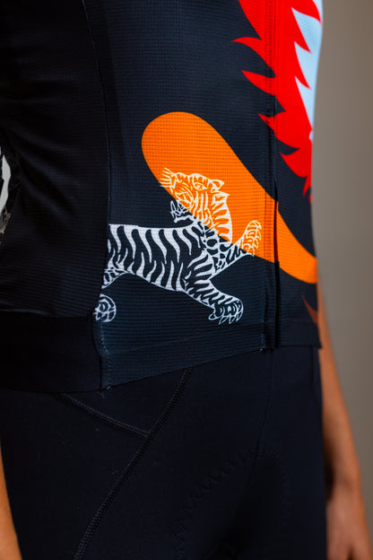 Close-up of tiger graphic and red floral print on Wild Bloom women's cycling jersey by Ardei