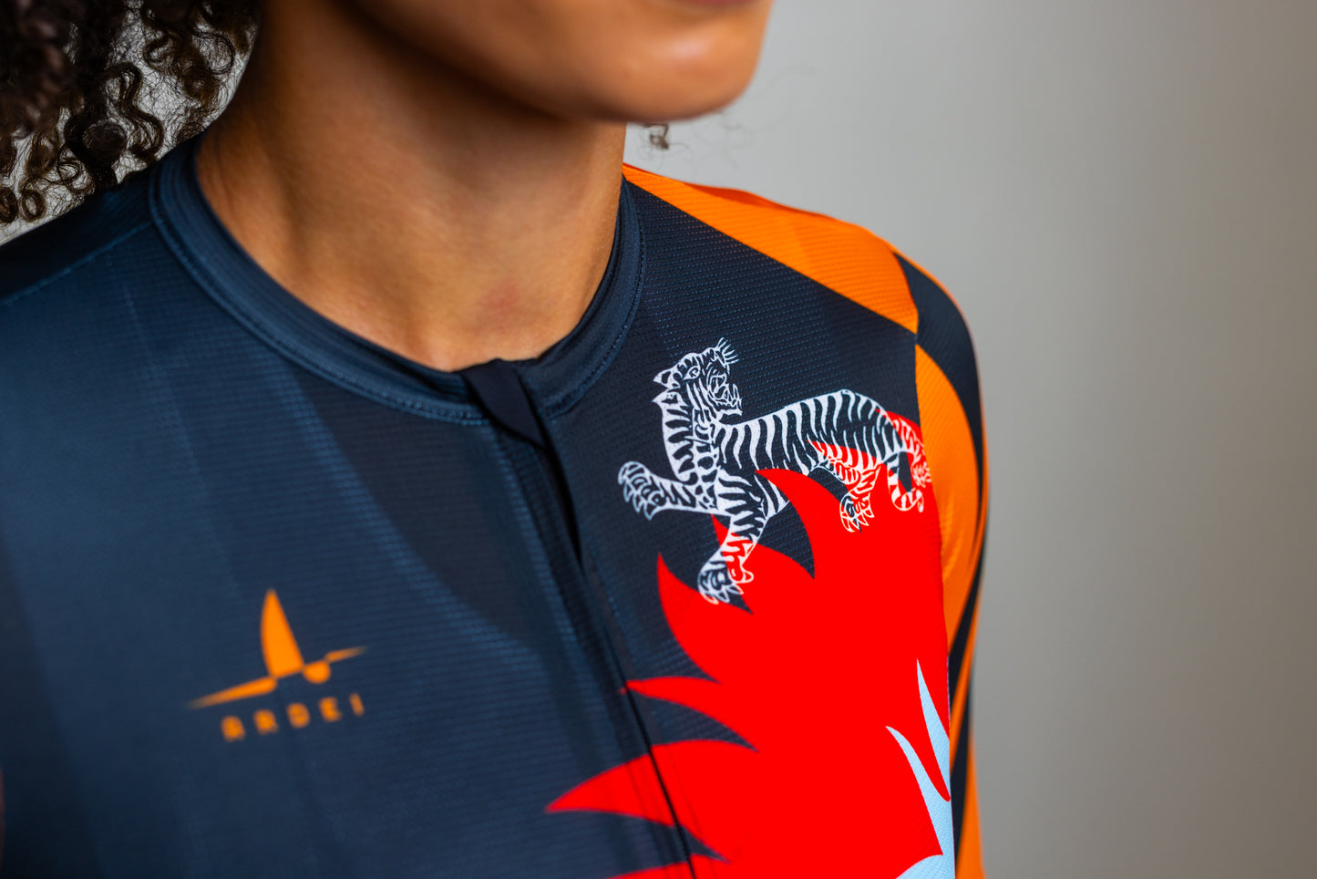 Close-up of chest detail with Ardei logo on black floral jersey