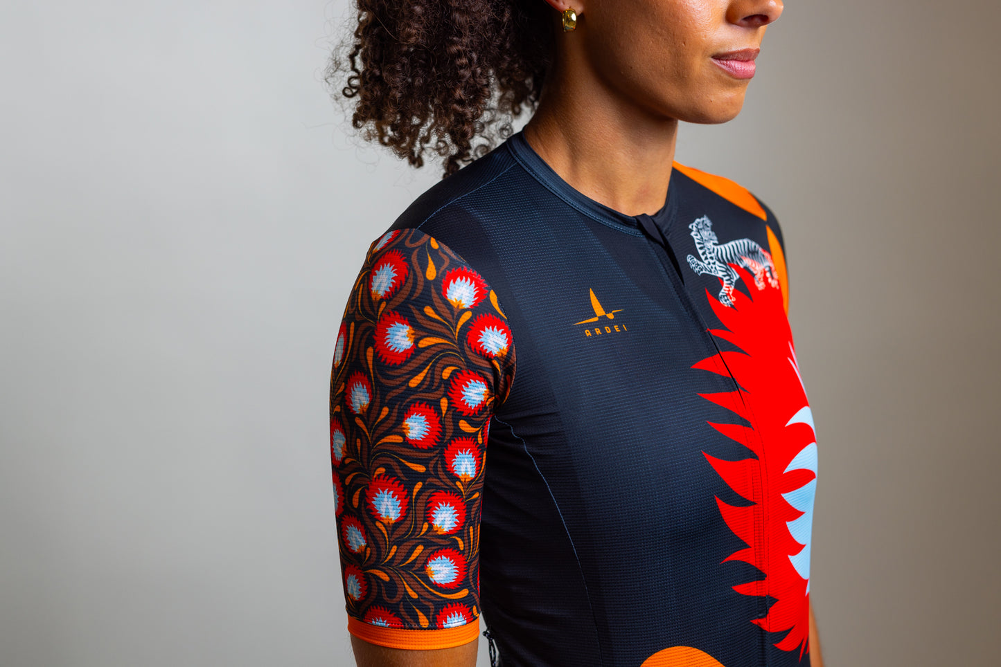 Side view of women's Wild Bloom cycling jersey with red floral pattern