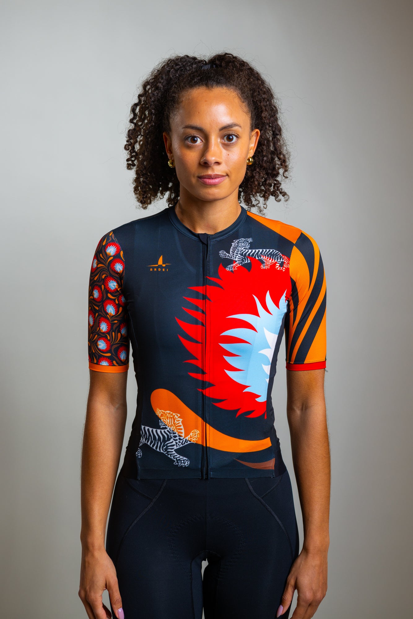 Front view of Ardei black floral cycling jersey on model